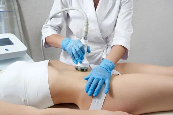 Lost the Weight but Not the Loose Skin? 2 woman having HIFU treatment on her stomach to combat loose skin Ashby Parva following weight loss
